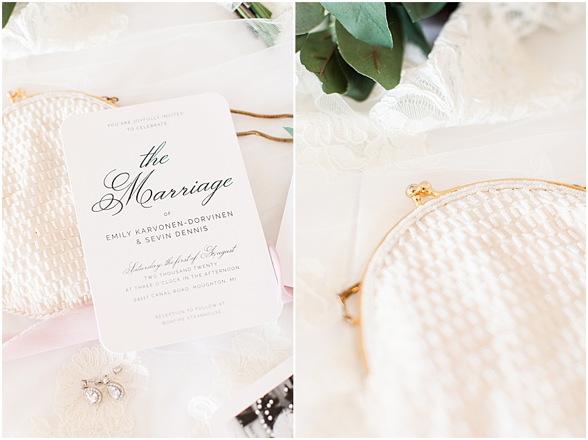 Close up image of white invitation with black modern text on the left, on the right is a close up image of a white antique purse with white bedding and a gold clasp 